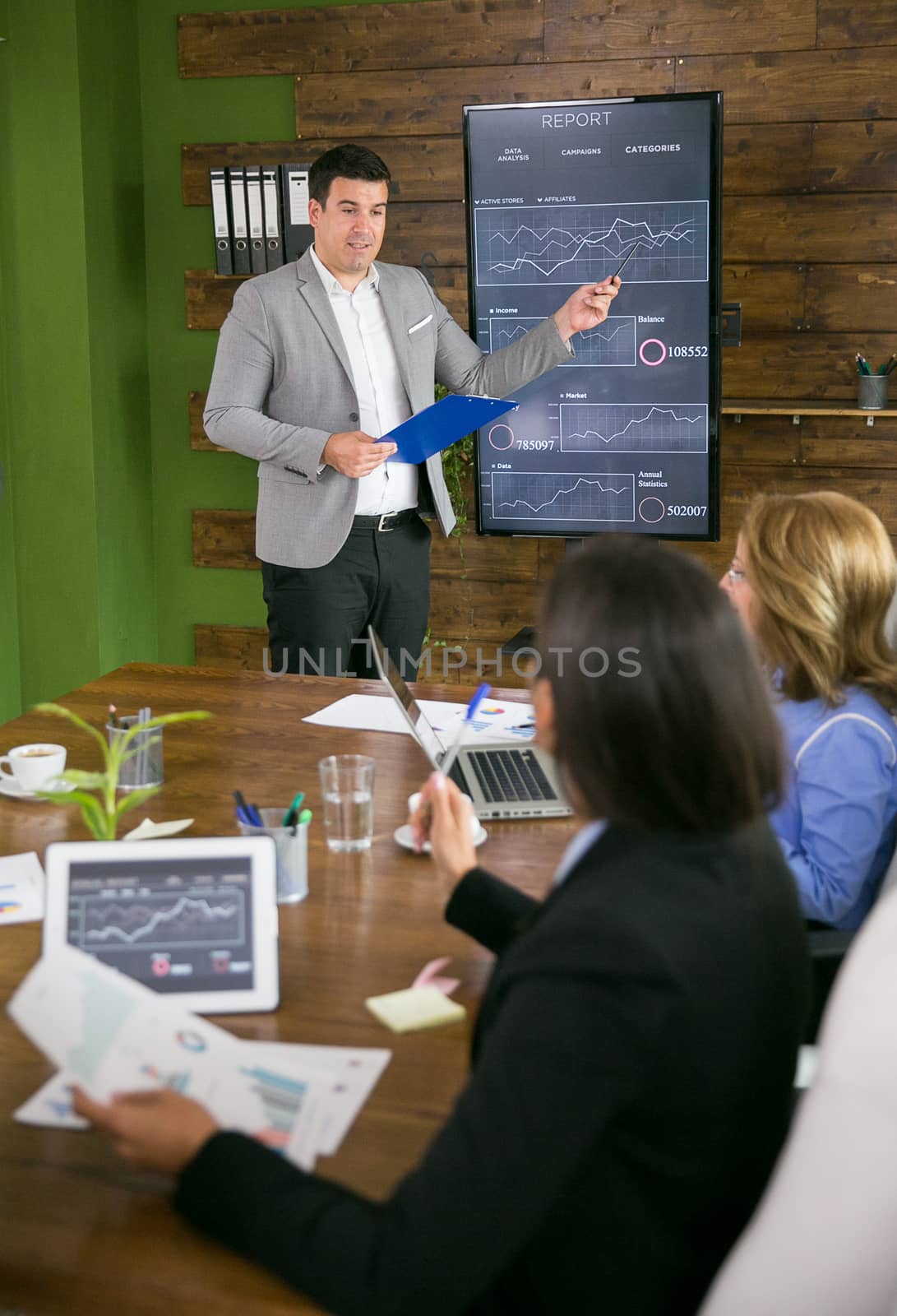 Young businessman presenting in front of leadership in the conference room.
