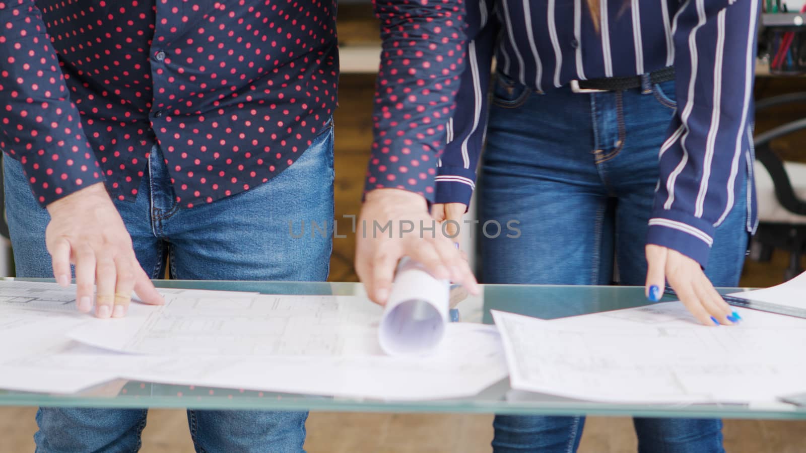 Close up shot of architects table with blueprints on it.