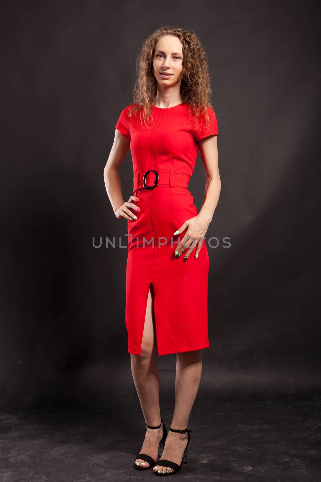 Full body portrait of sexy beautiful woman in red dress in studio. Caucasian beauty.