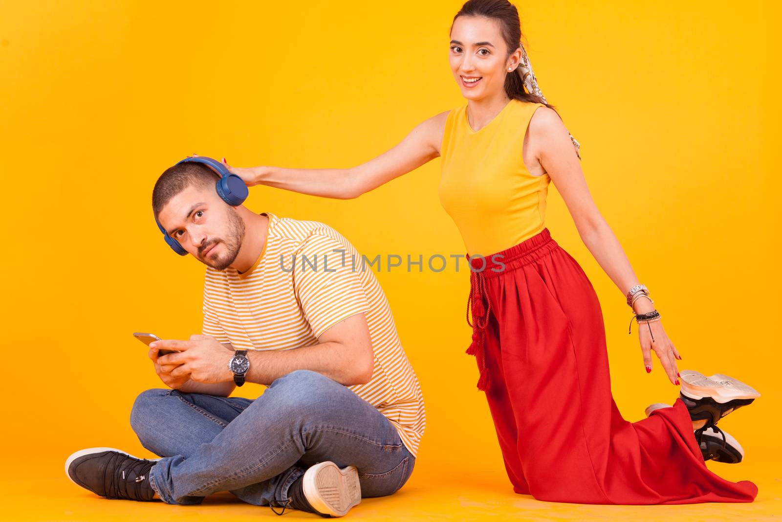 Girlfriend trying to get attention of his boyfriend because he's ignoring her.