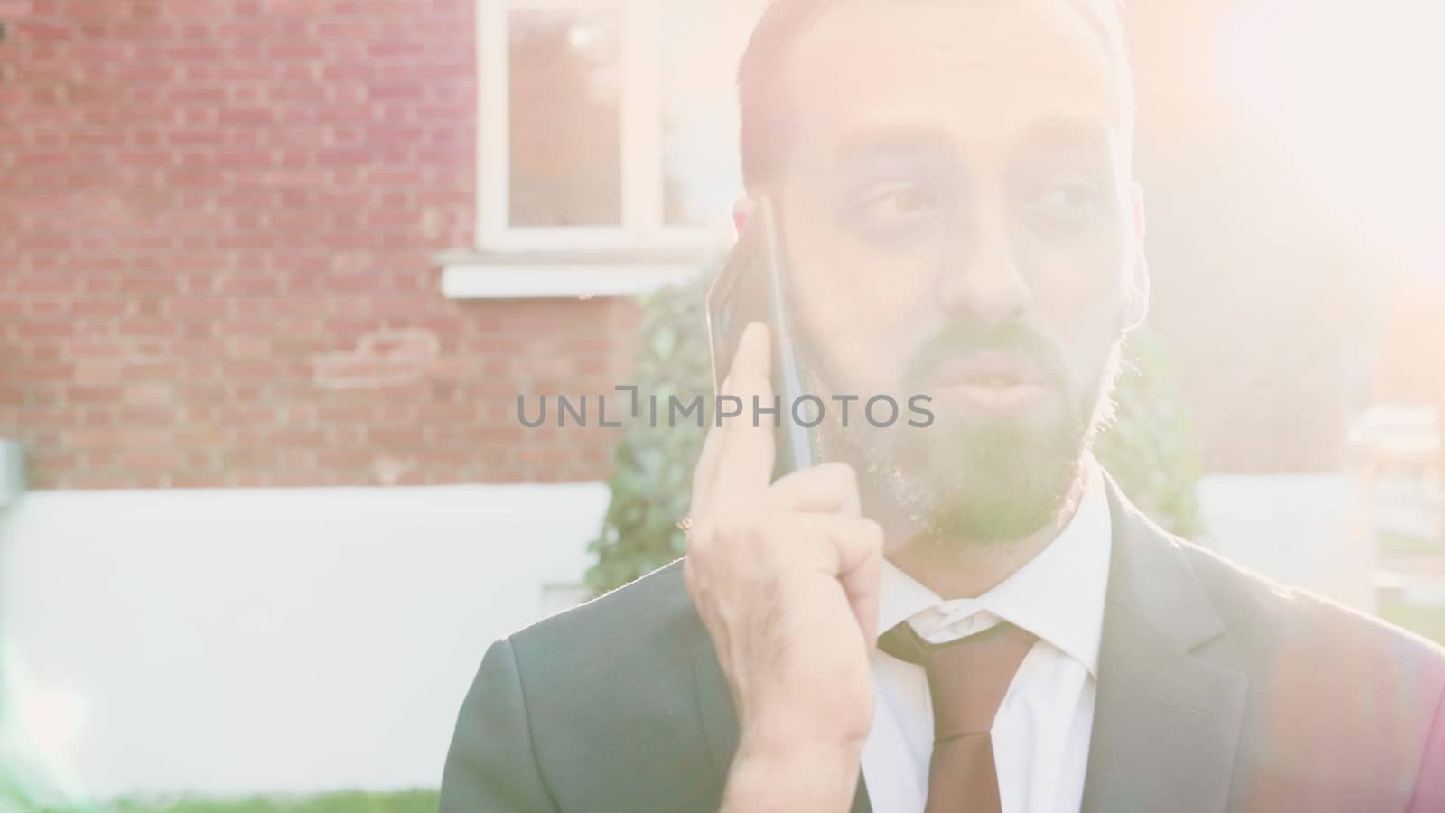 Manager having a conversation on the phone, outdoor in the city. Sof selective focus, slow motion footage