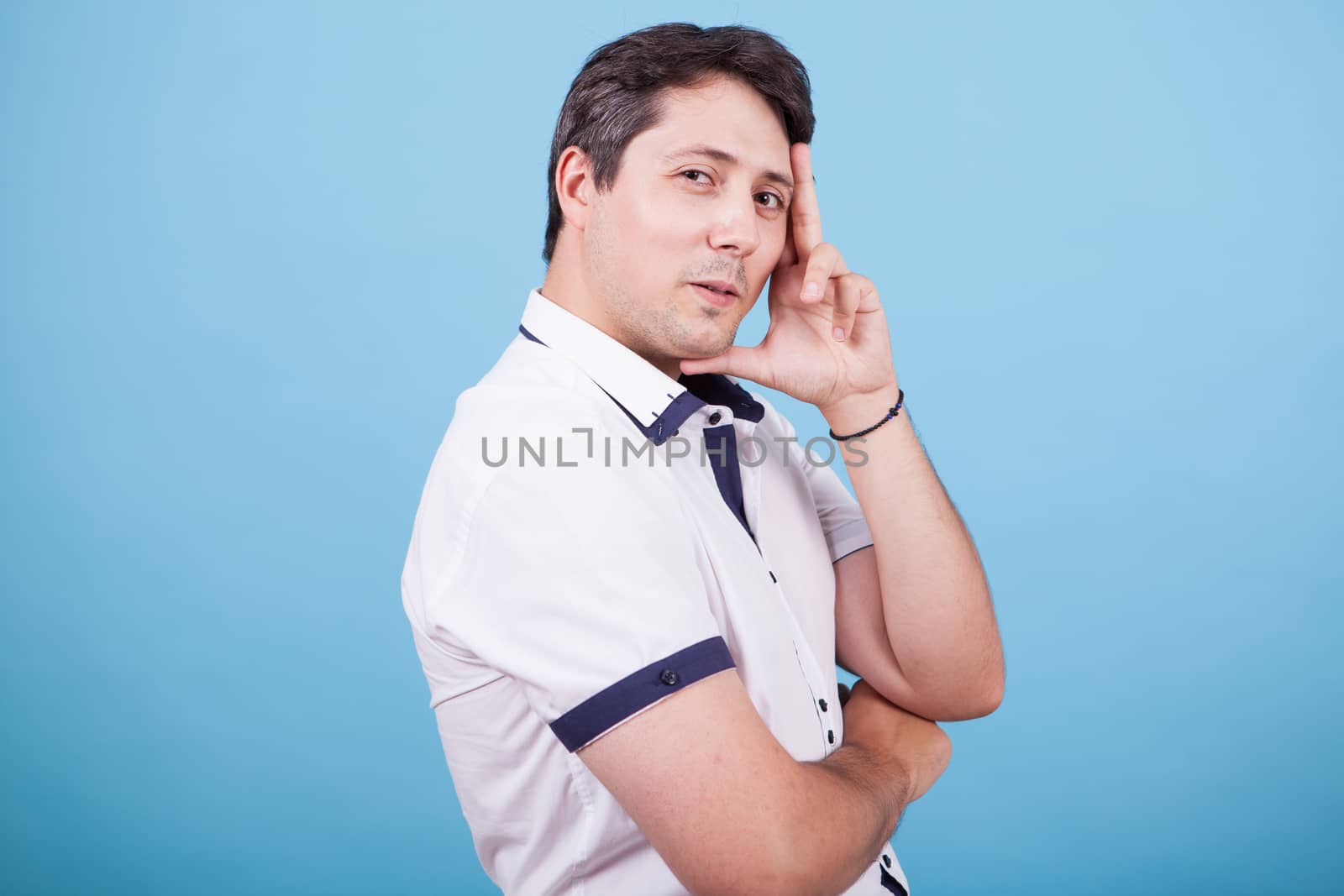 Side view portrait of young caucasian male smiling. Thinking man.