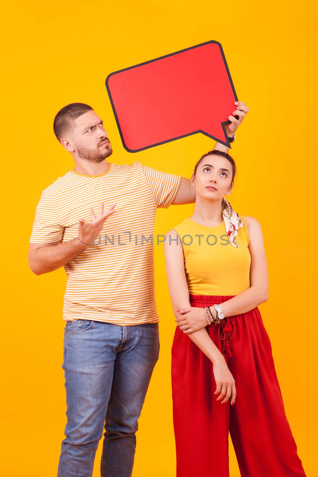 Confused boyfriend pointing at bubble thought and girlfriend looking up.