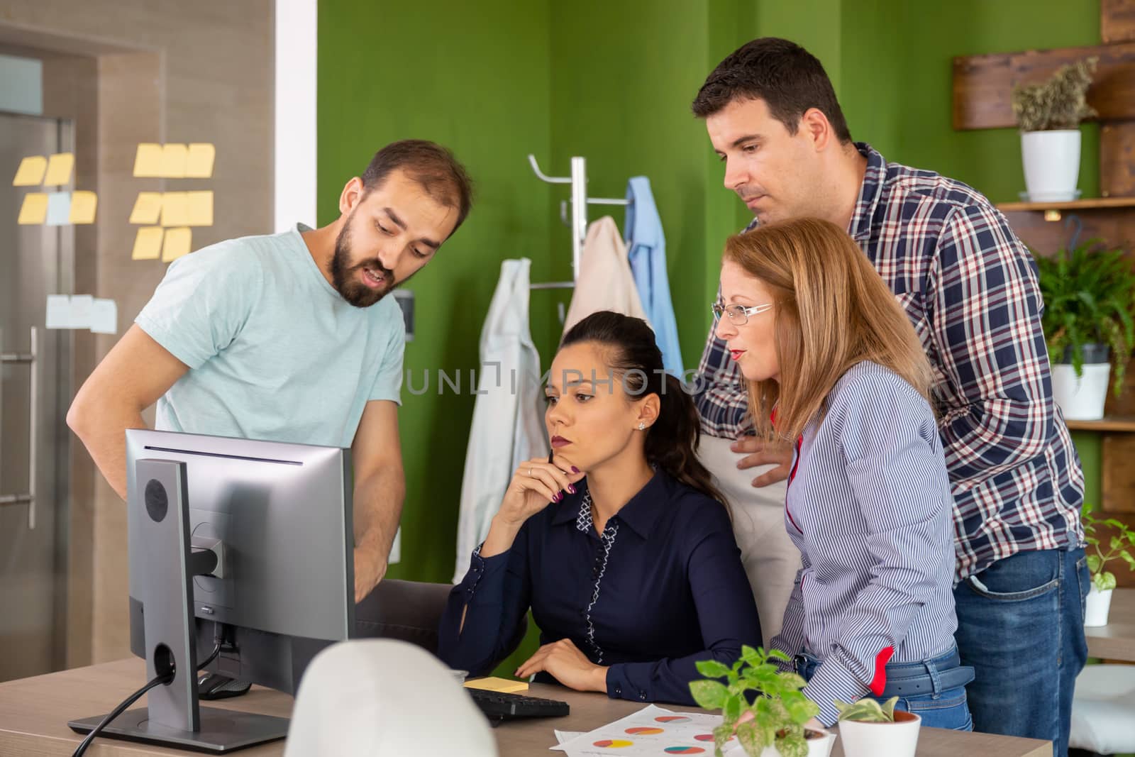 In start-up company office team is brainstorming on new project. Teamwork and communication