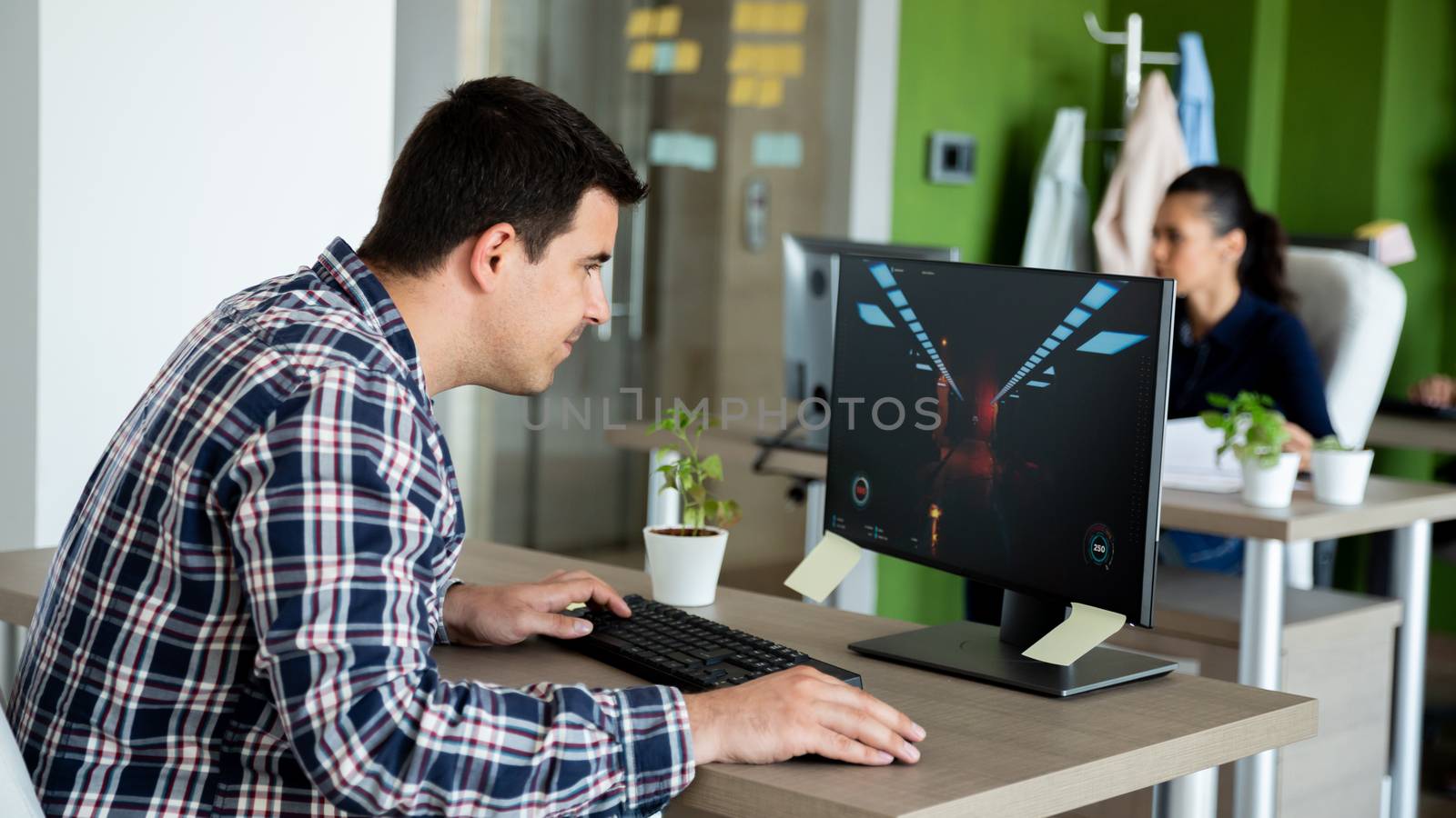 Player playing video games in modern office. Concentrate the screen