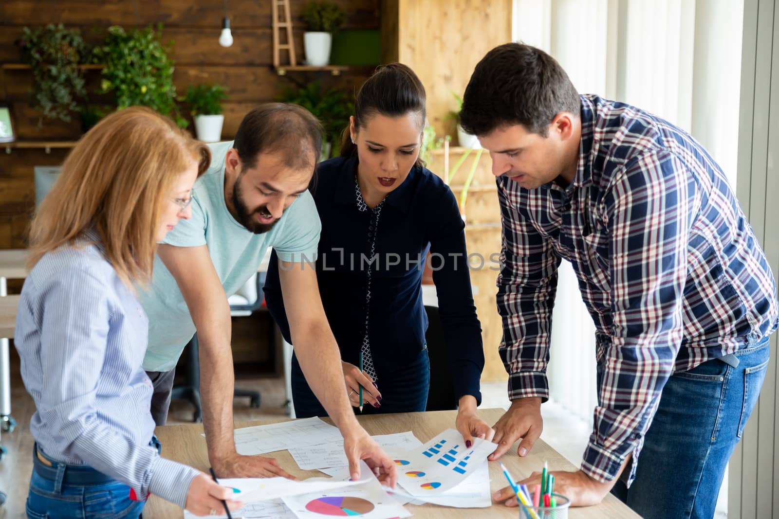 Employees discuss the latest changes in the project. Teamwork and brainstorming