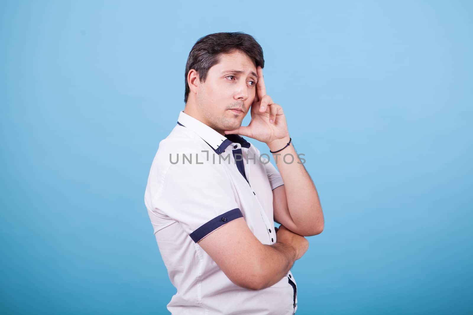 Side view portrait of young caucasian man looking concerned. Facial expression.