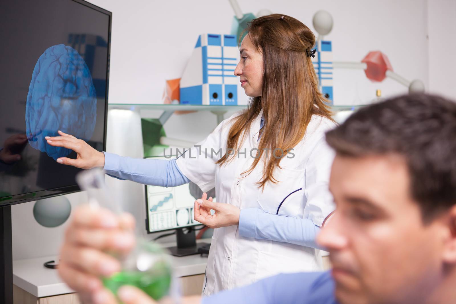 Middle age female scientist doing doing advanced analysis on human brain. Genetic experiments.