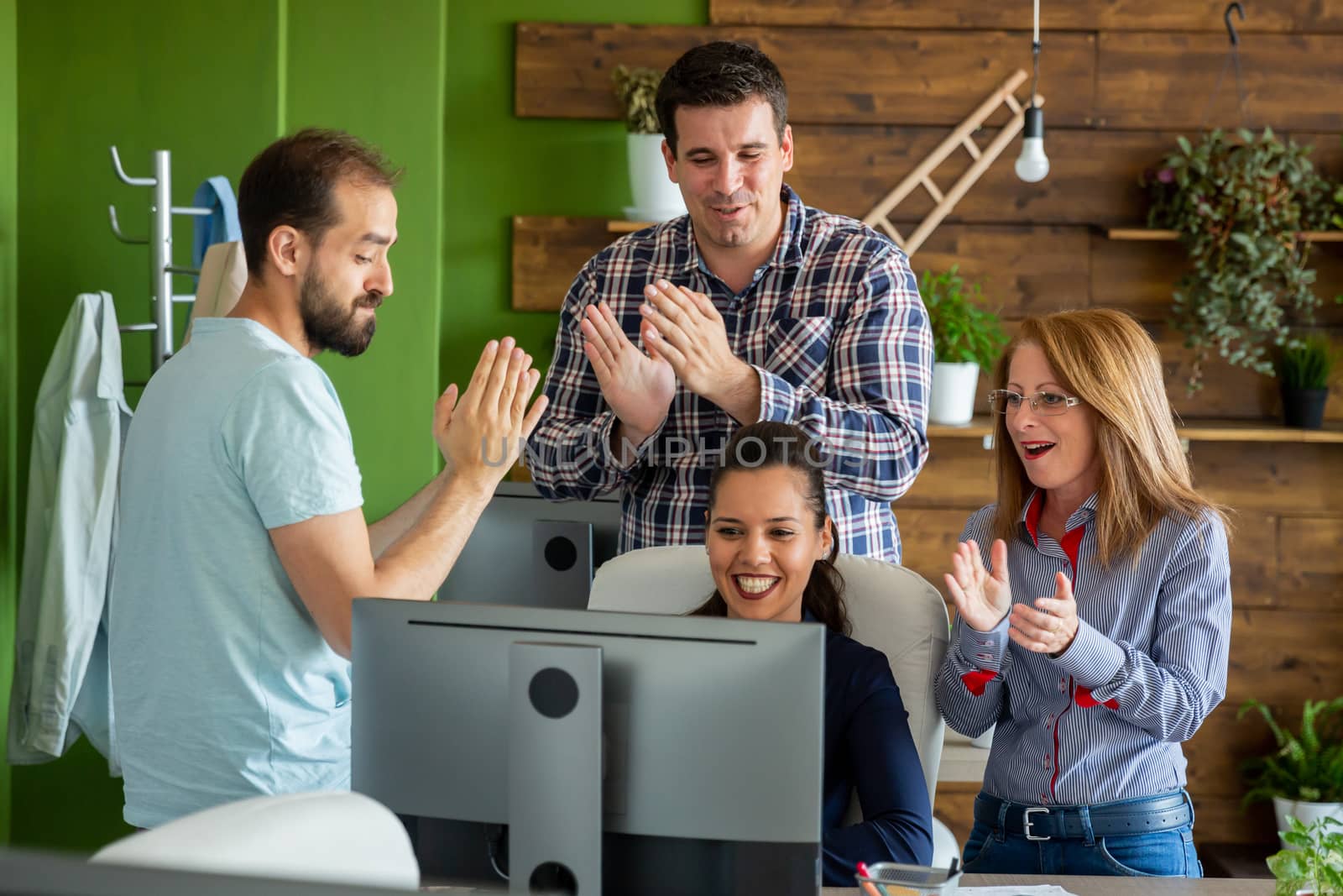 Celebrating a successful partnership in modern start-up company office