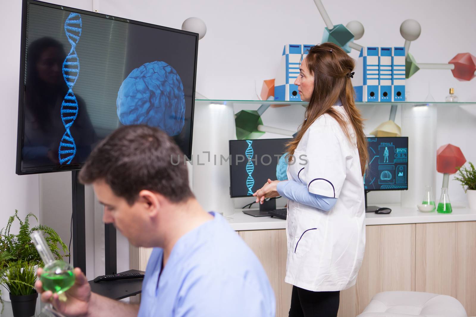 Middle age female scientist analysing a brain after dna modification in a research lab. Plant modification effect on human brain.