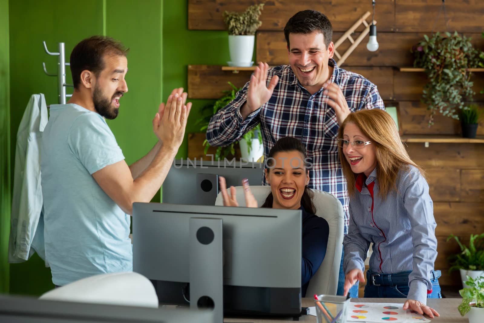Successful business team celebrating a big sale. Start-up company