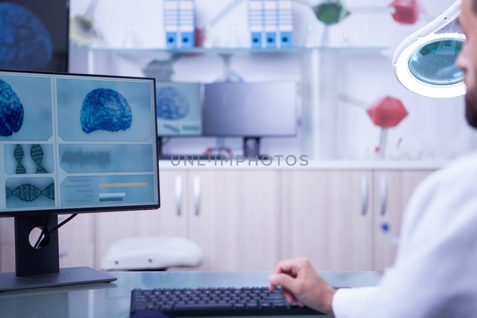 Photo of a brain x-ray examined by a young doctor. Control room in a hospital laboratory.