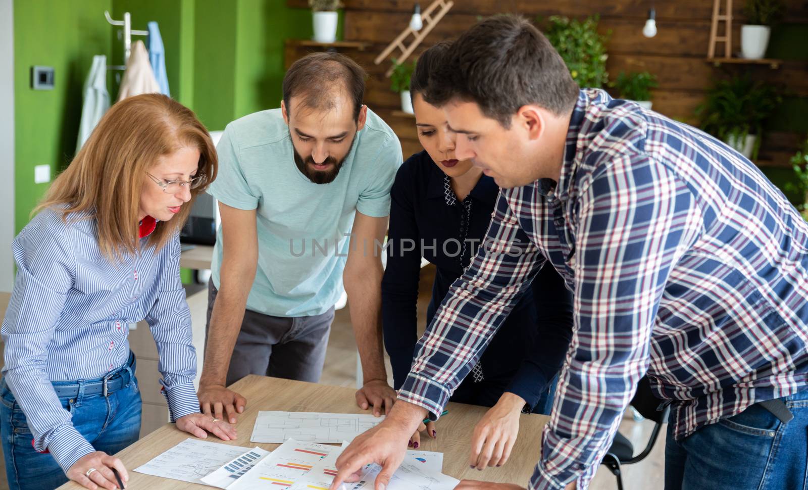 Business people in cozy office talk of new project. Young people