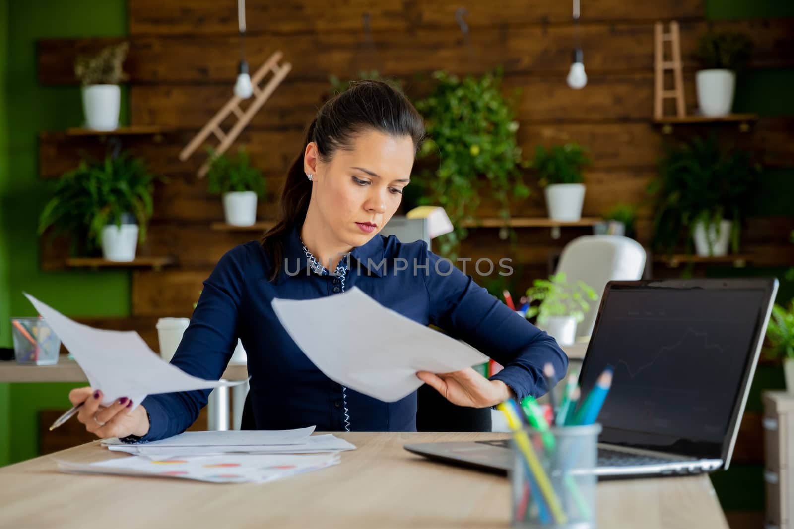 Brunette girl work in modern office.Start-up cozy office