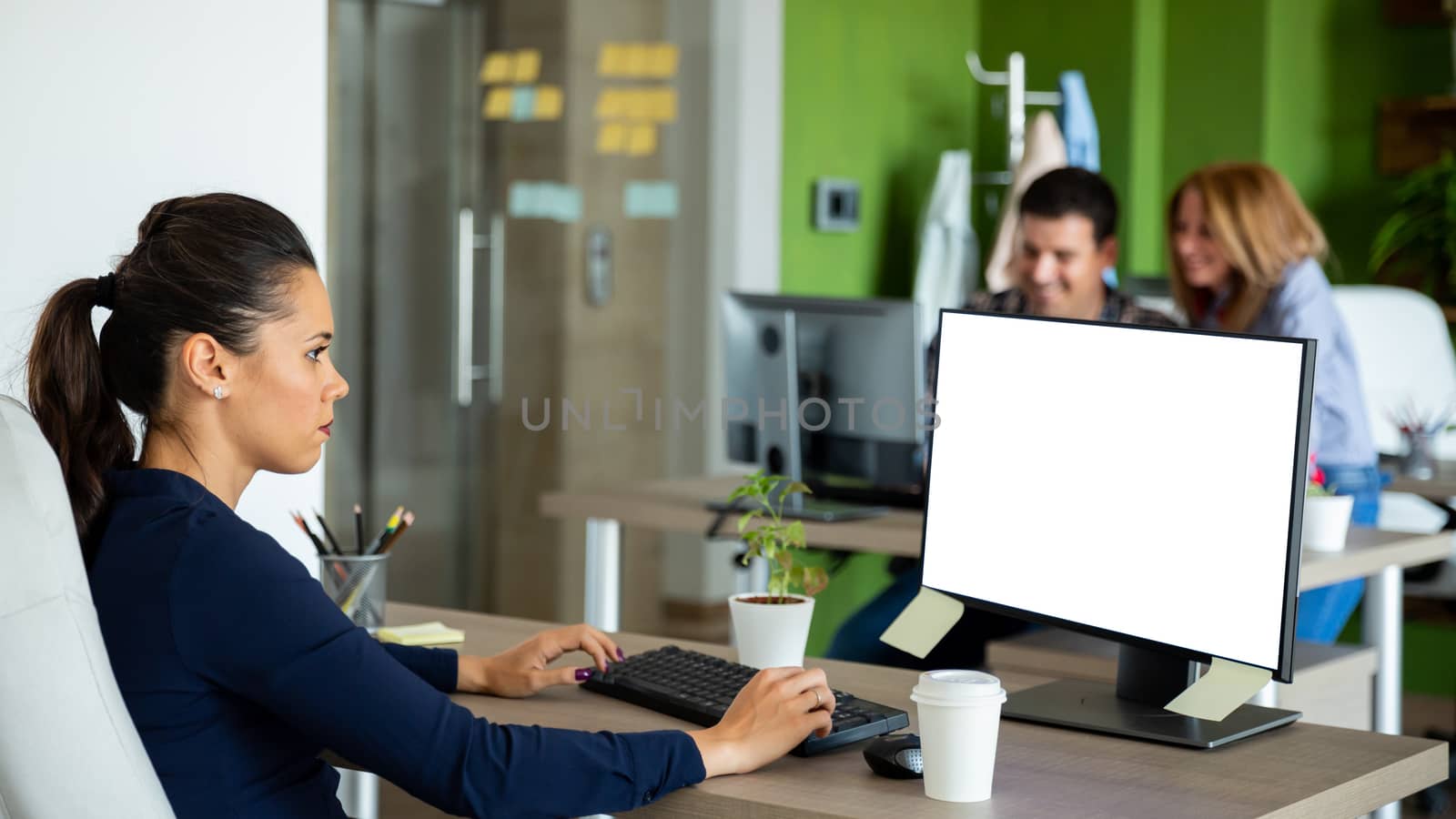 Beautiful businesswoman work on the computer and look to screen