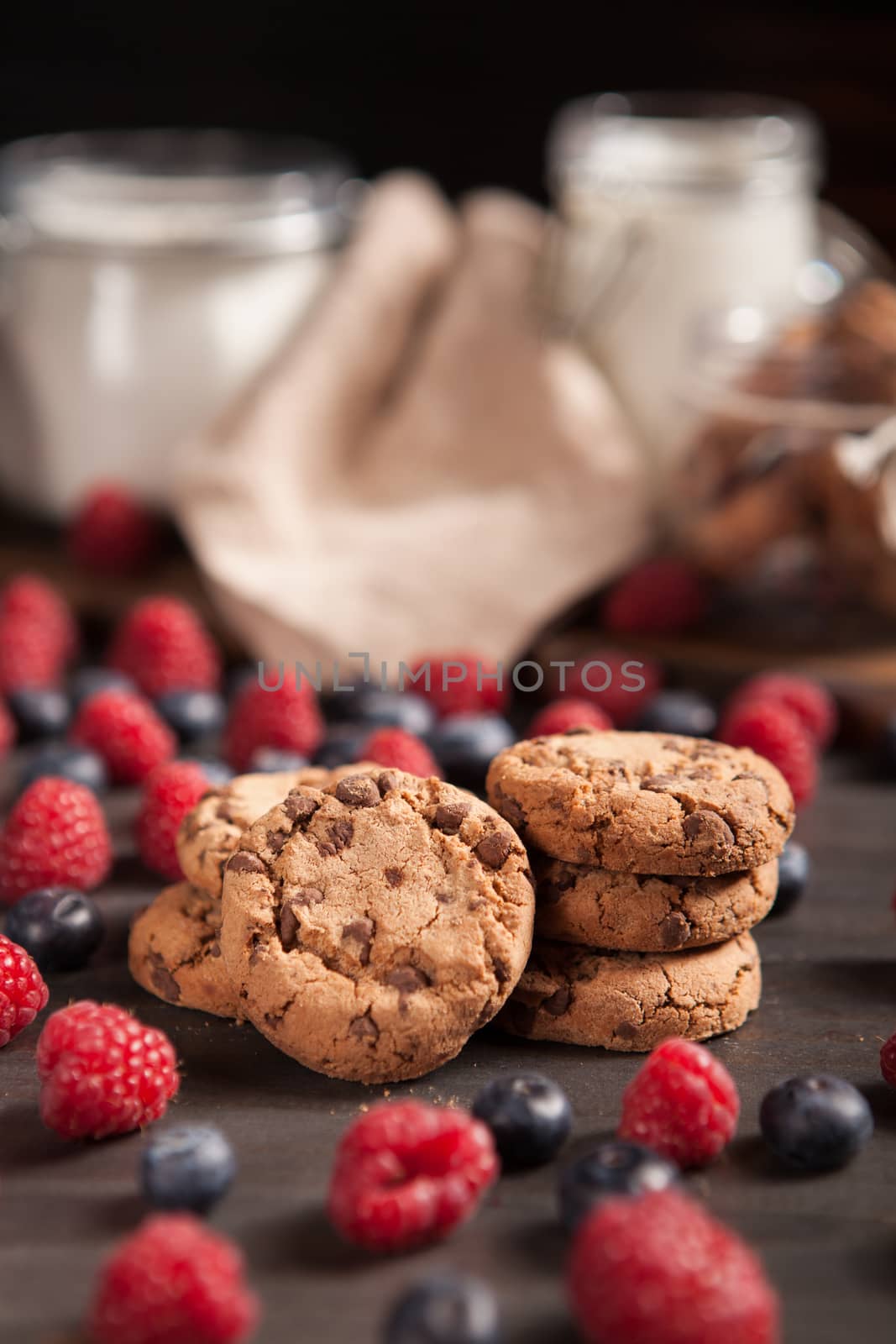 Delicious treat for morning breakfast with chocolate biscuits and milk. Fresh raspberries.