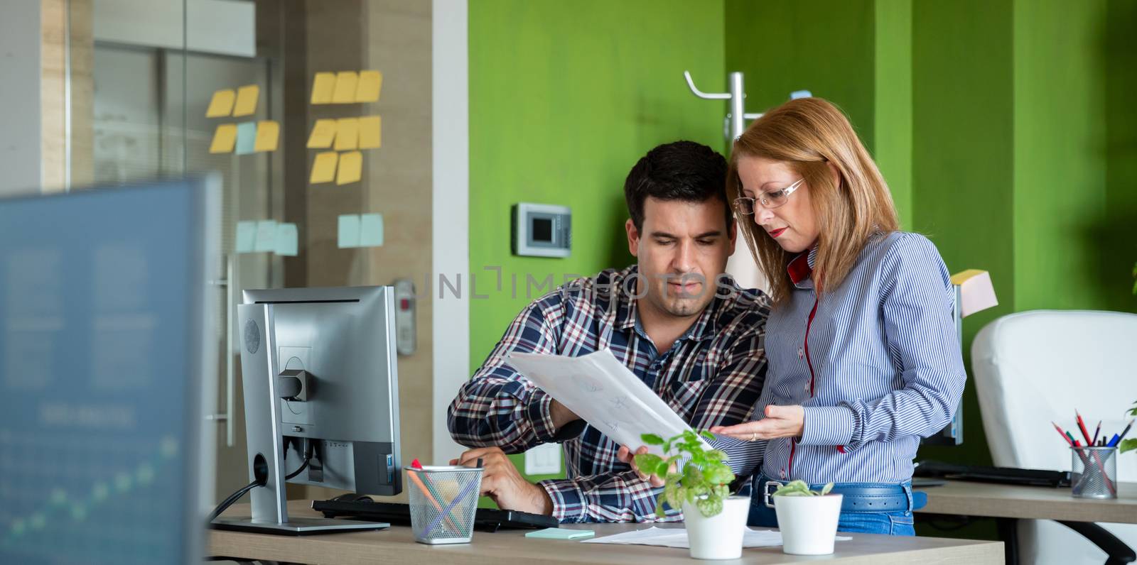 Two colleagues look over a chart. Annual report