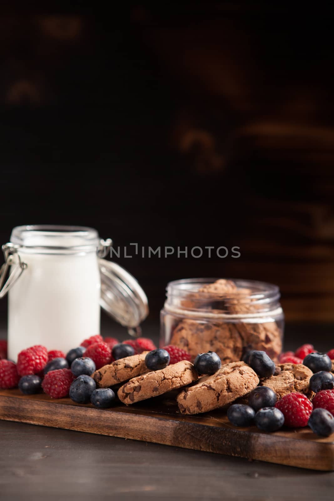 Delicious and organic chocolate chips ready to be eaten from a wooden plate. Tasty biscuits.