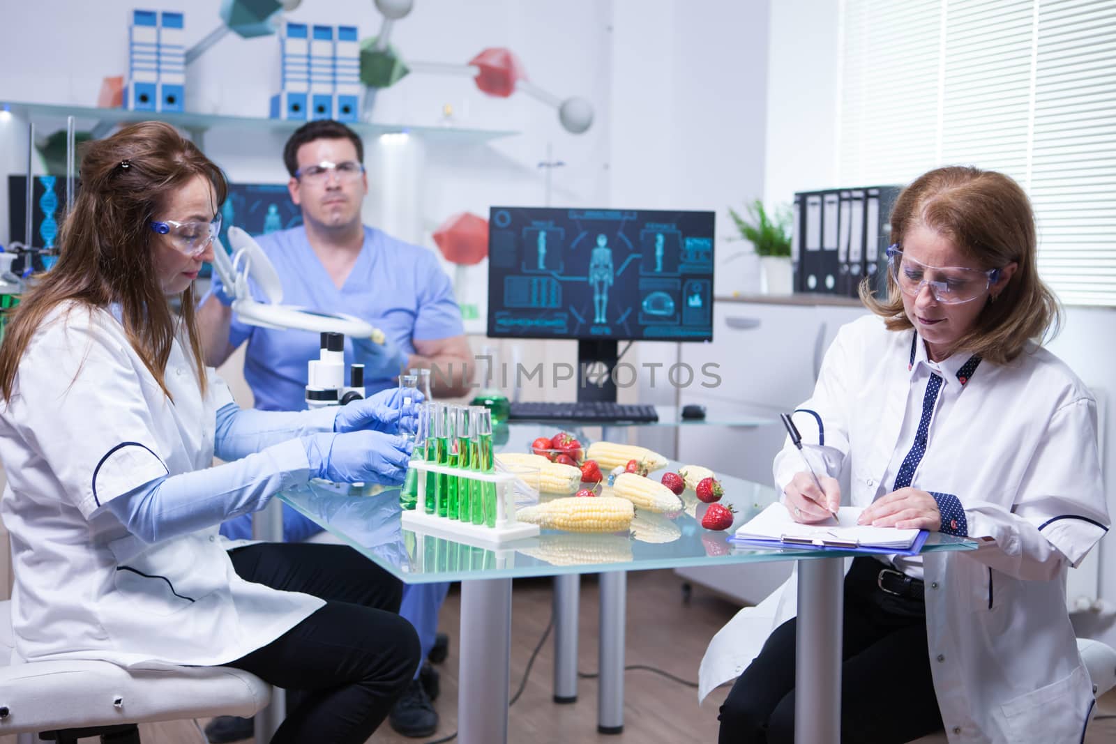 Caucasian female scientist writing down notes after ending quality inspection on strawberries. Strawberries analysis.