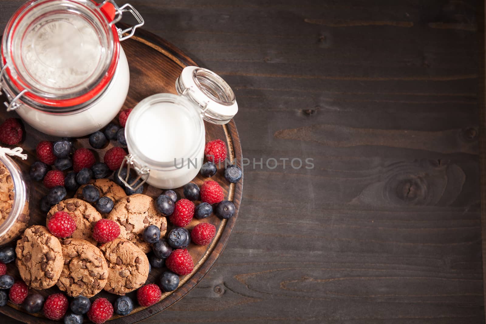 Top view of delicious and healthy breakfast made out of oatmel chocolate biscuits. Fresh bluebarries. Copy space available.