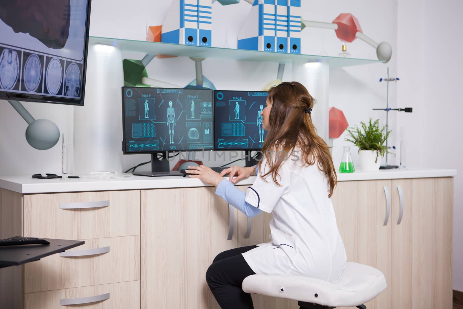 Female genetic scientist checking how food changes human body on computer in a laboratory. . Microbiological laboratory.
