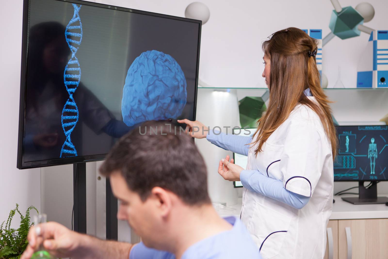 Research scientist pointing at monitor in a research lab for human health. Brain analysis.