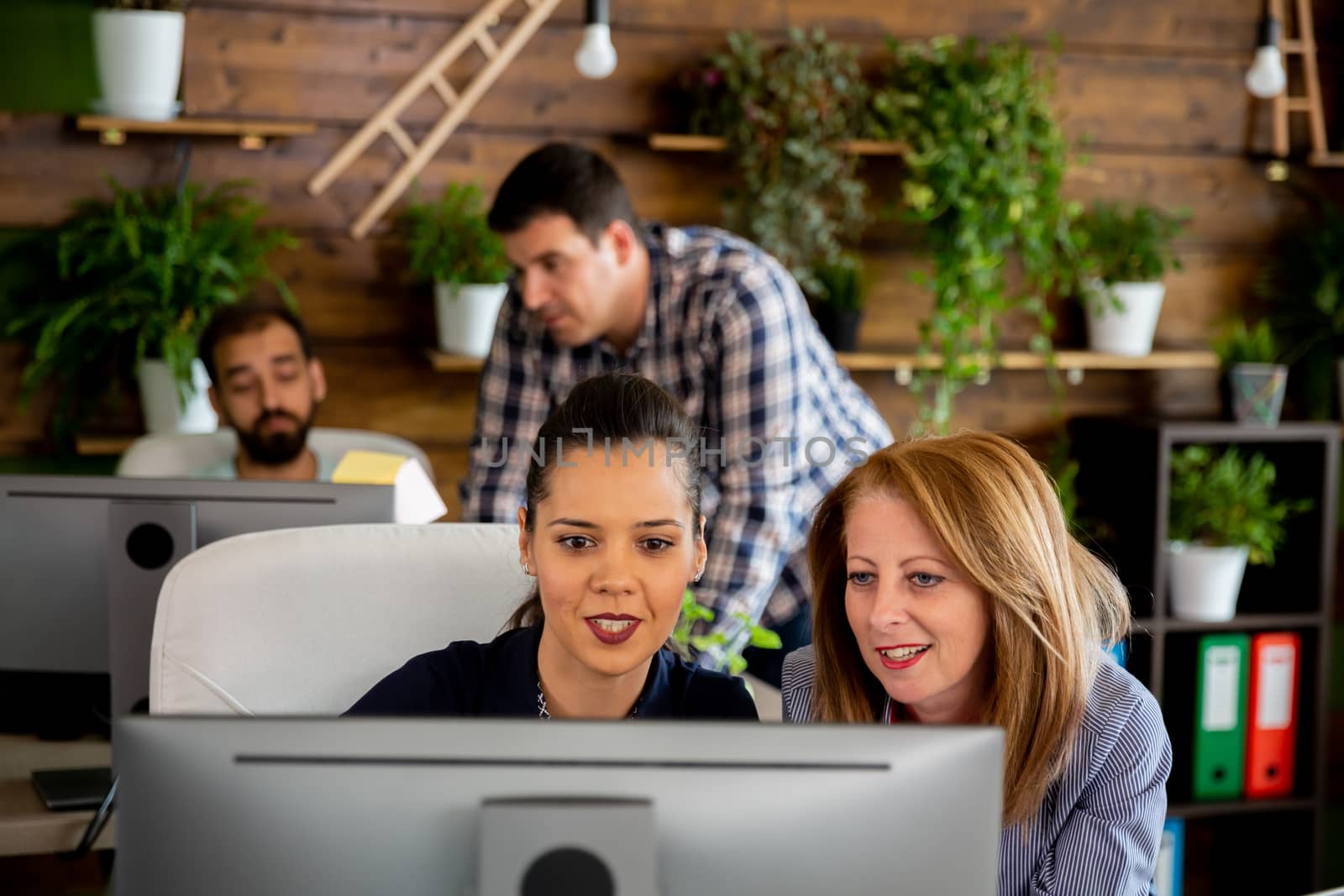 Modern company office with people working at their desks. Employee and manager