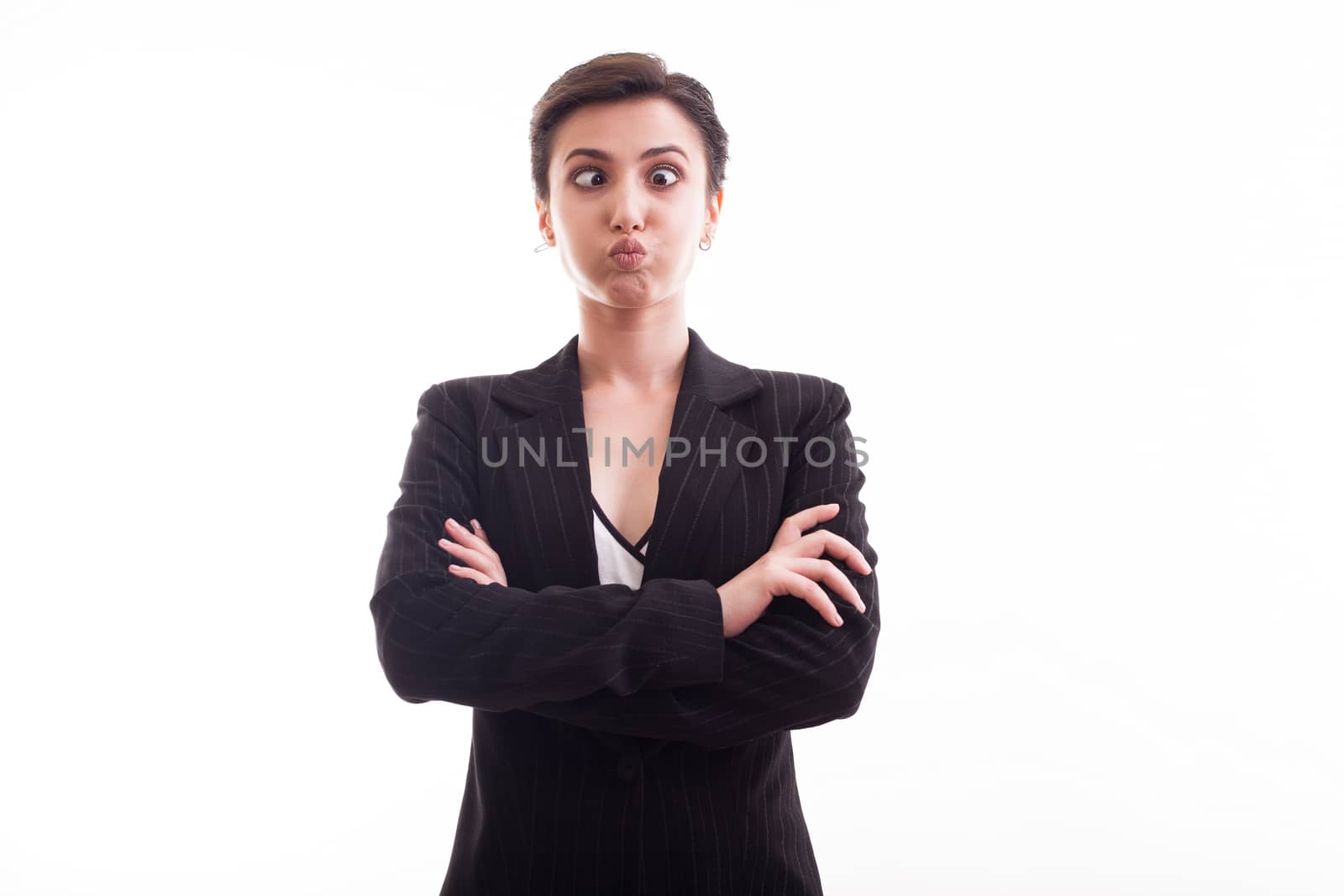 Beautiful young girl doing funny face while wearing a black jacket in studio over white background. Girl feeling funny.