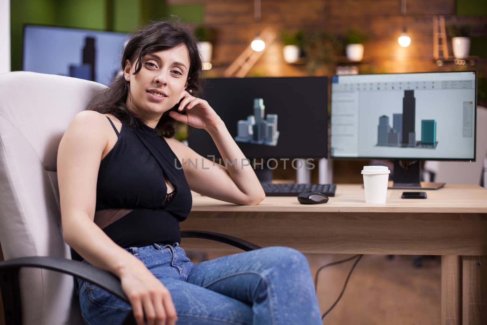 Portrait of beautiful young woman smiling to the camera in her office. Business owner.