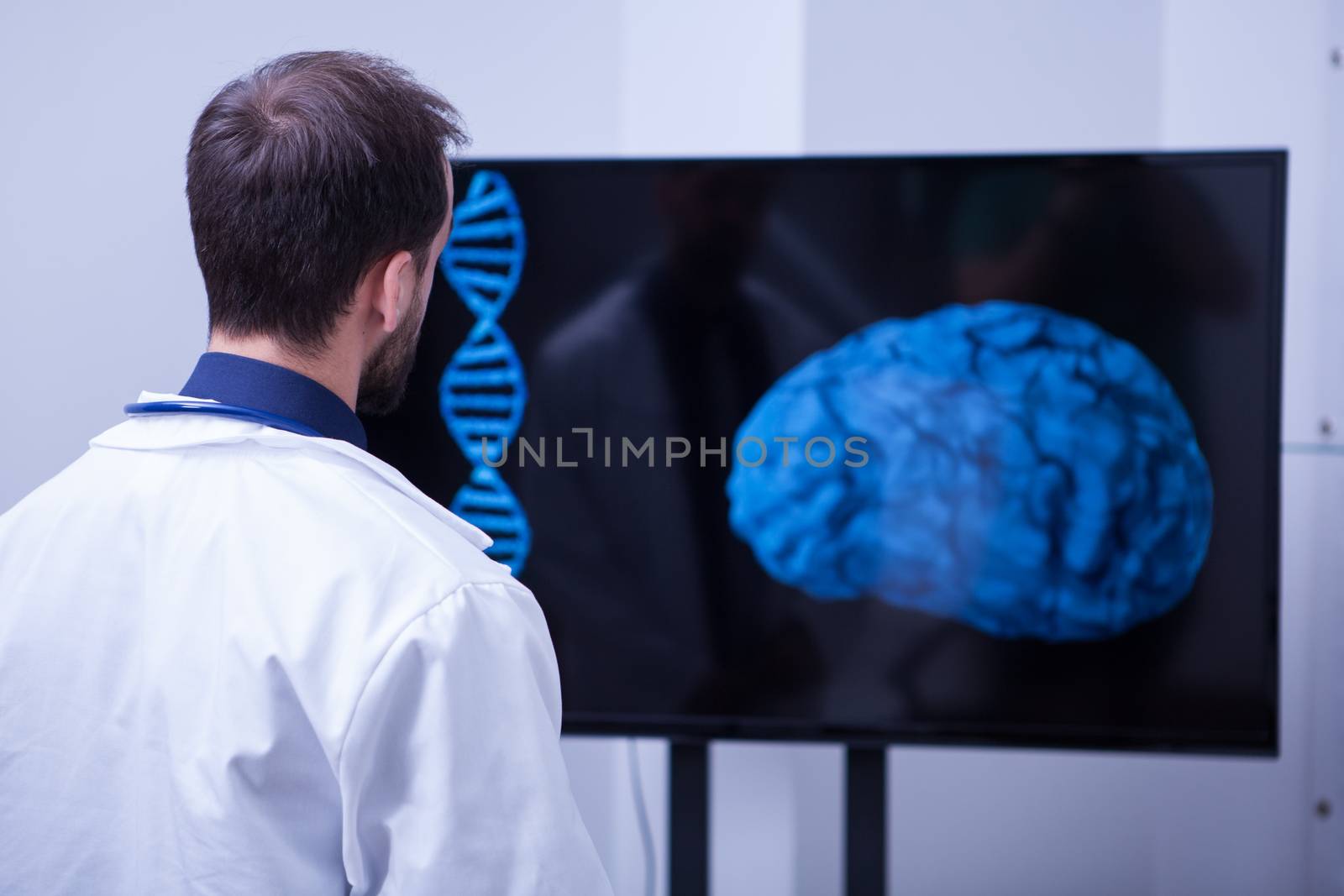 Young Brain surgeon lookin a this patient brain aftter the surgery. Doctor using moder technology from the hospital.