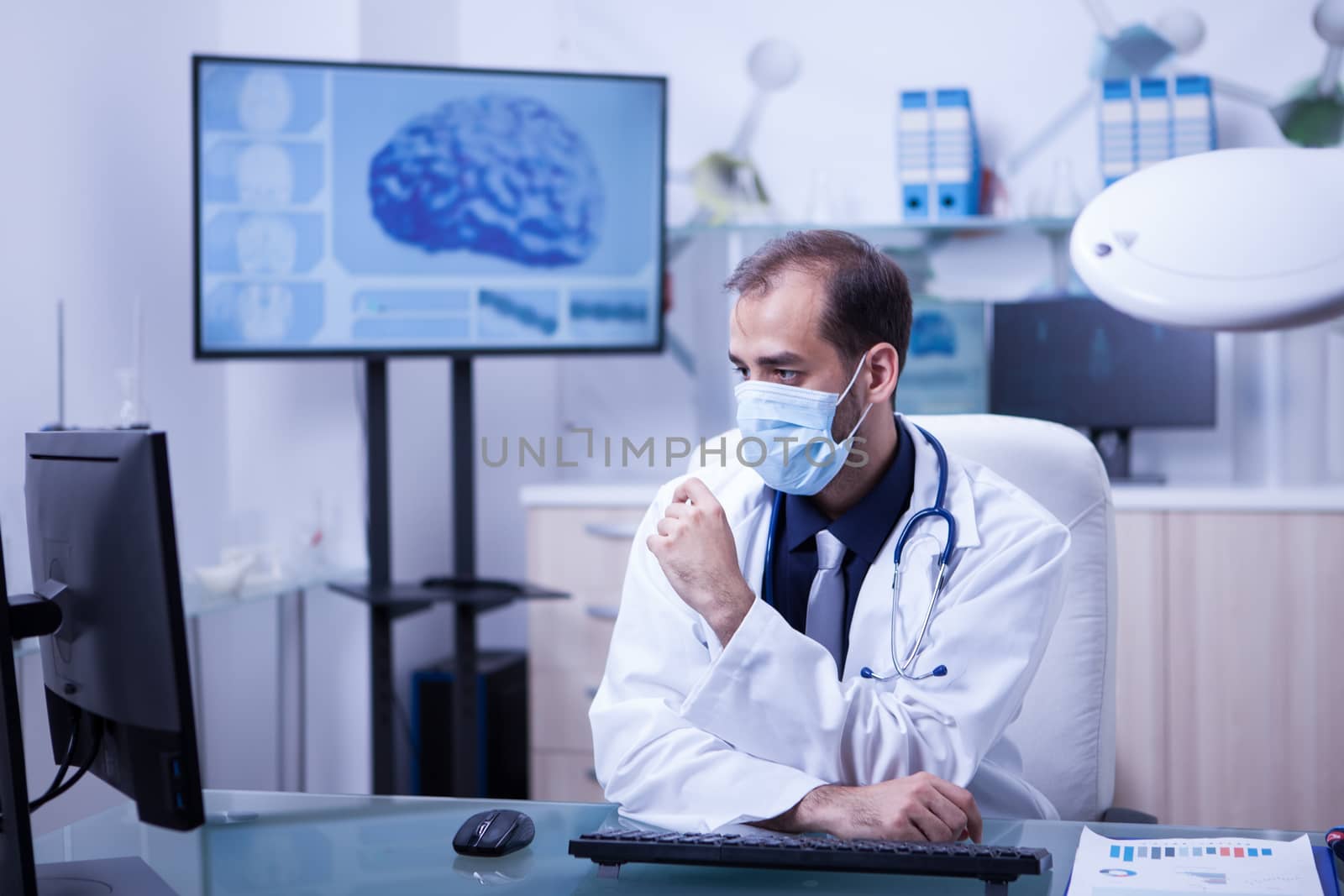 Concentrating doctor on his work at the cabing with his mout covered. Doctor with protection mask.