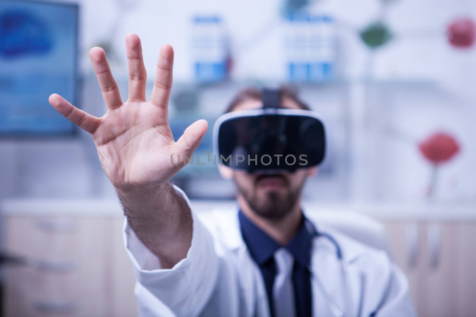 Bearded male doctor working with virtual reality headset. Medicine technology.
