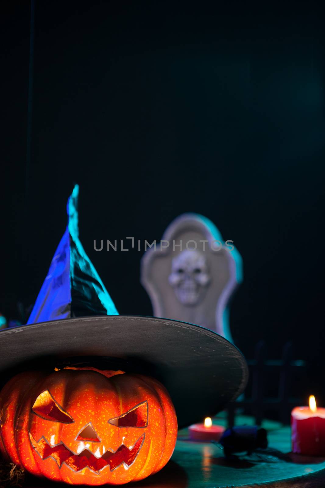 Creepy halloween pumpking with a witch hat on top. Spooky pumpking.