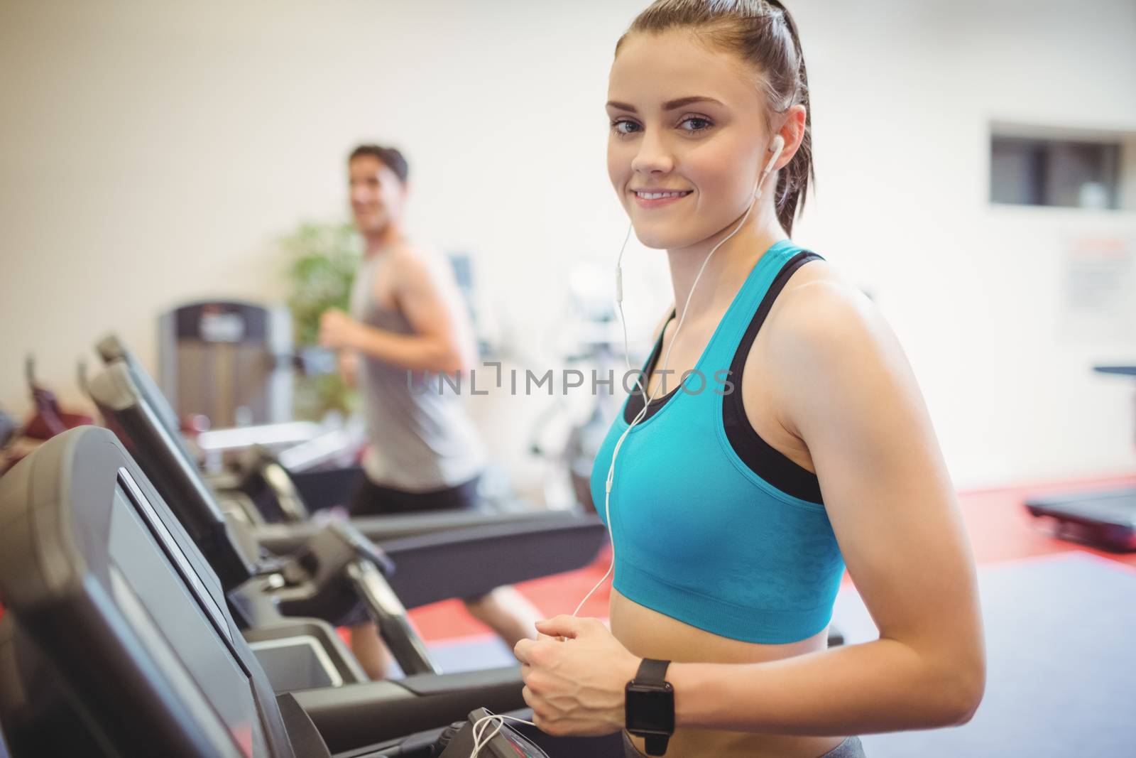 Fit people using the treadmill at the gym