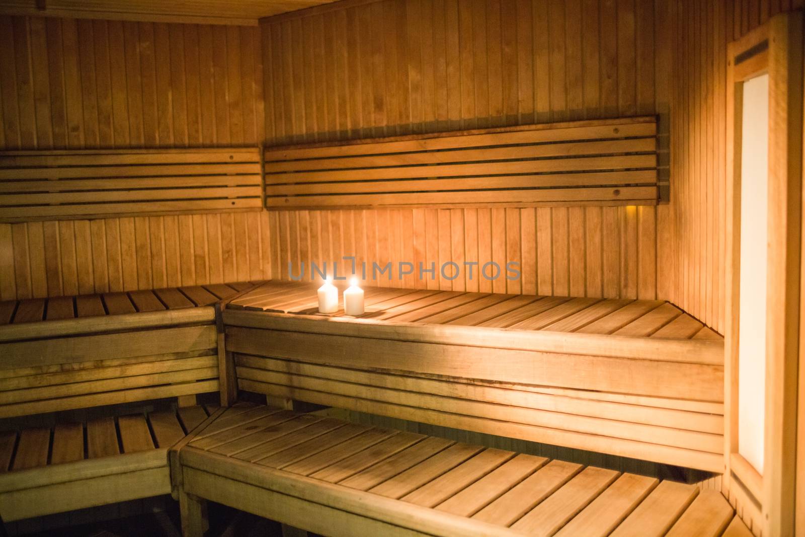 Candles lighting in a sauna by Wavebreakmedia