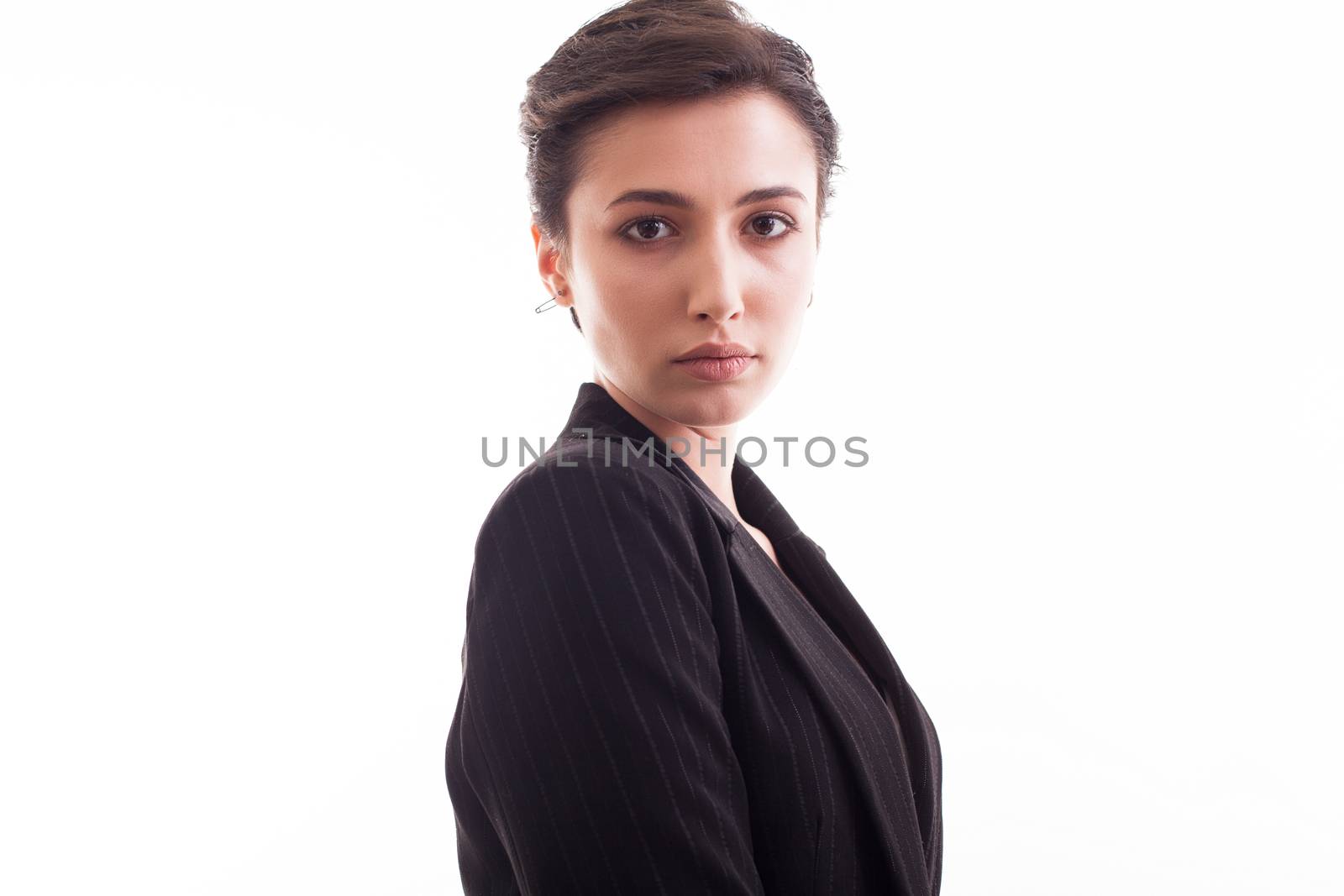 Side view portrait of beautiful young girl wearing a black jacket over white background. Girl in her 20s.