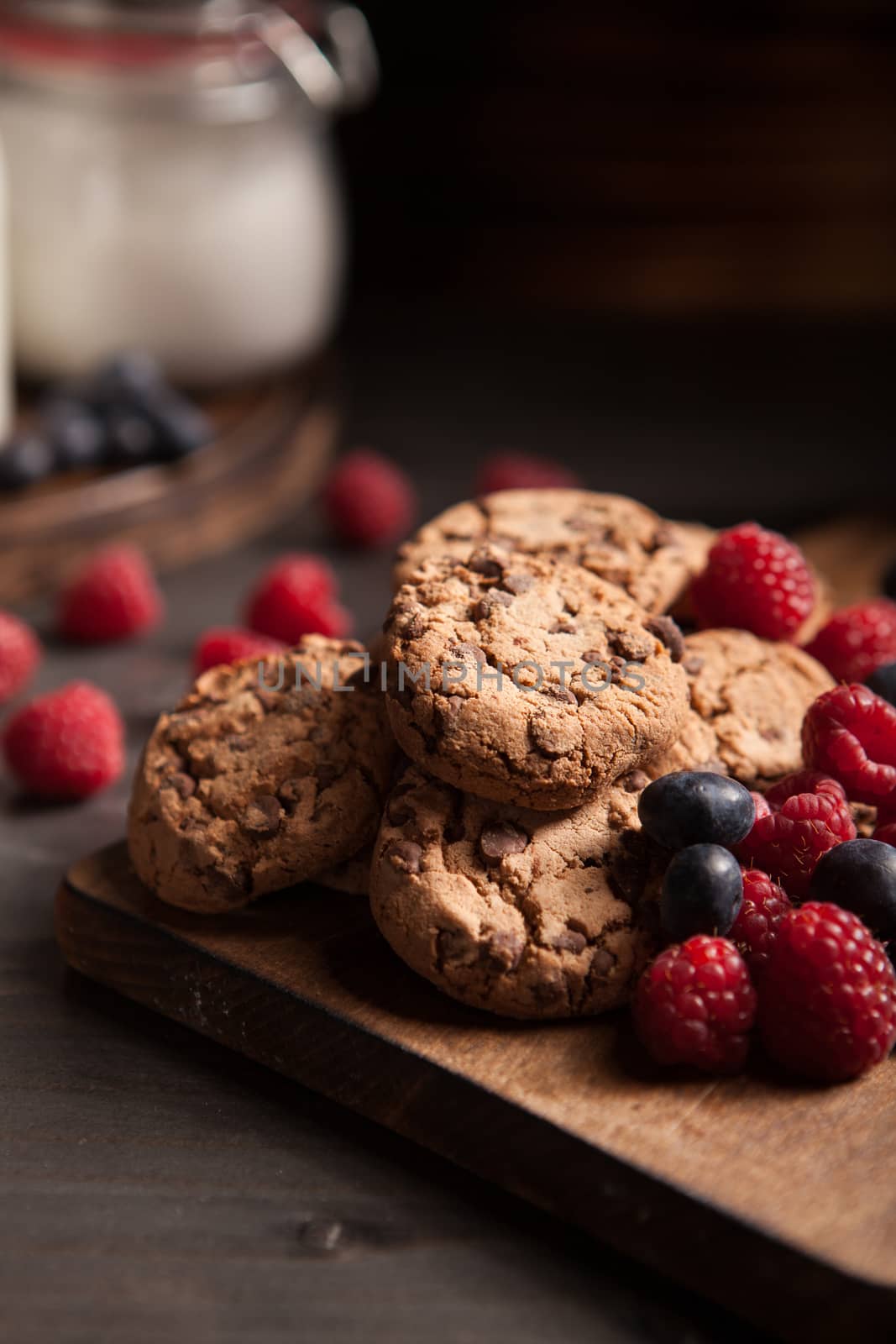 Delicious chocolate cookies for breakfast with milk and blueberries. Healthy biscuits.