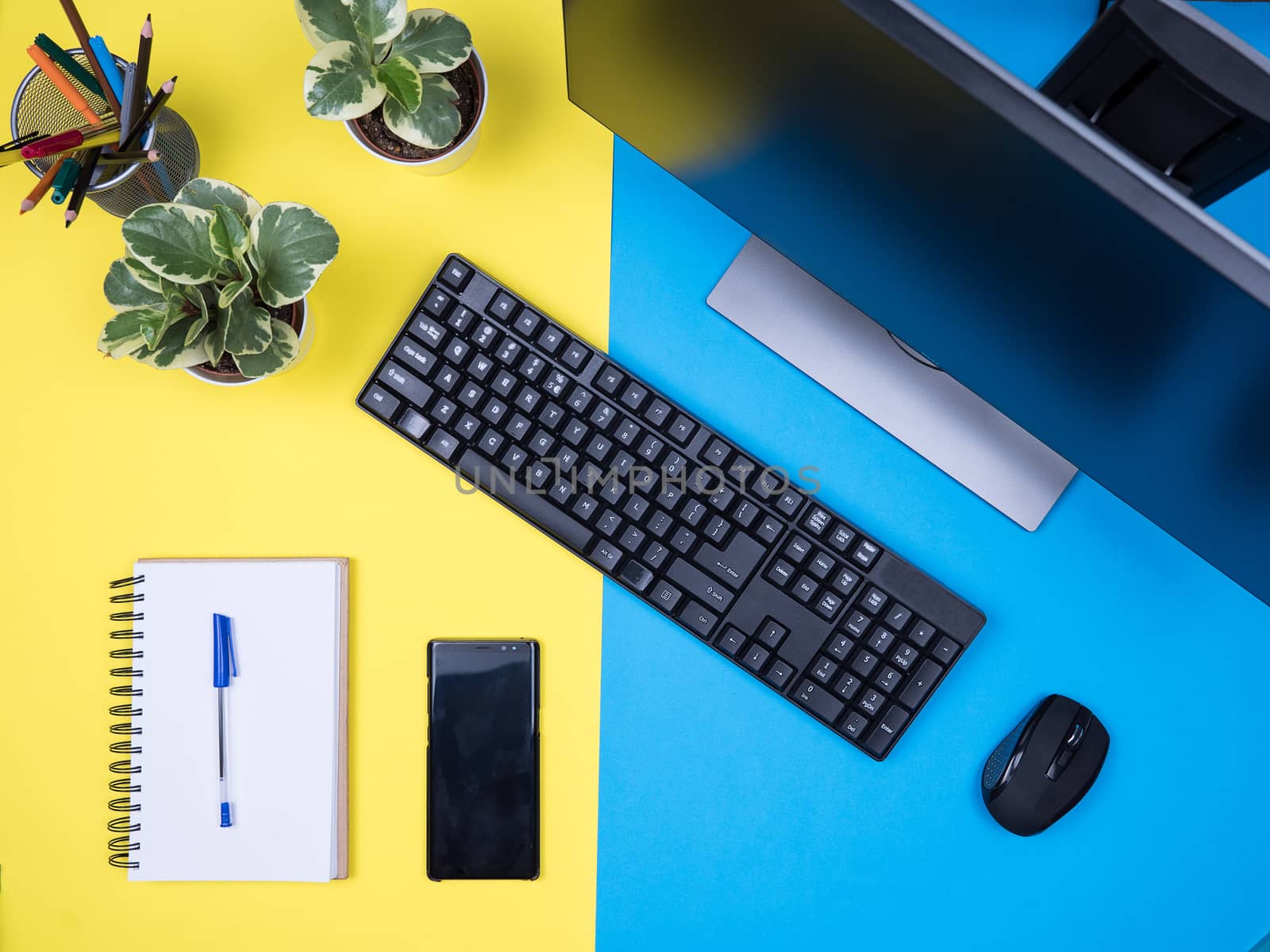Flat lay top view of workplace concept over blue background. Modern Monitor. Business man notebook.