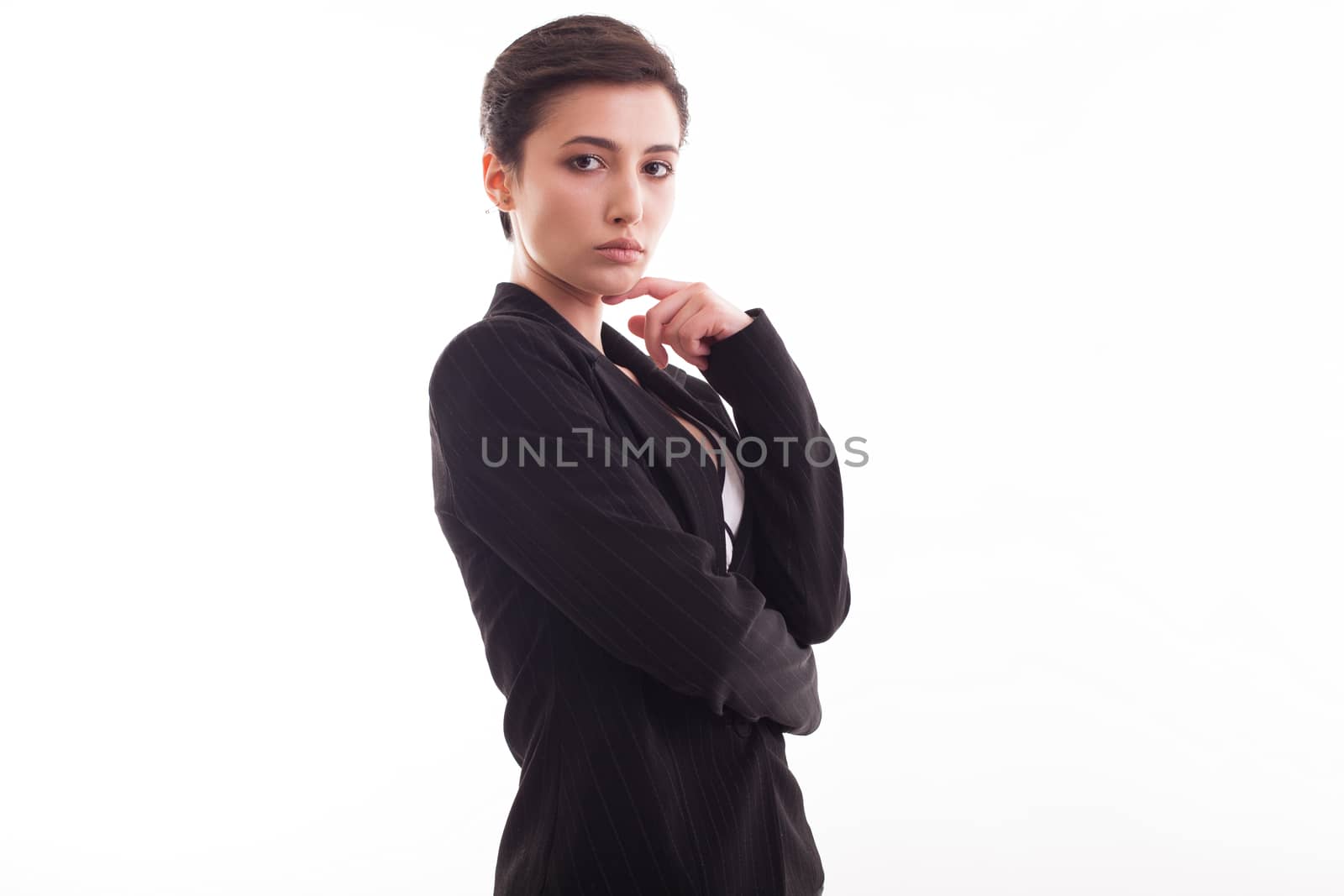 Attractive young woman in stylish black jacket posing over white background looking at the camera. Modern outfit.