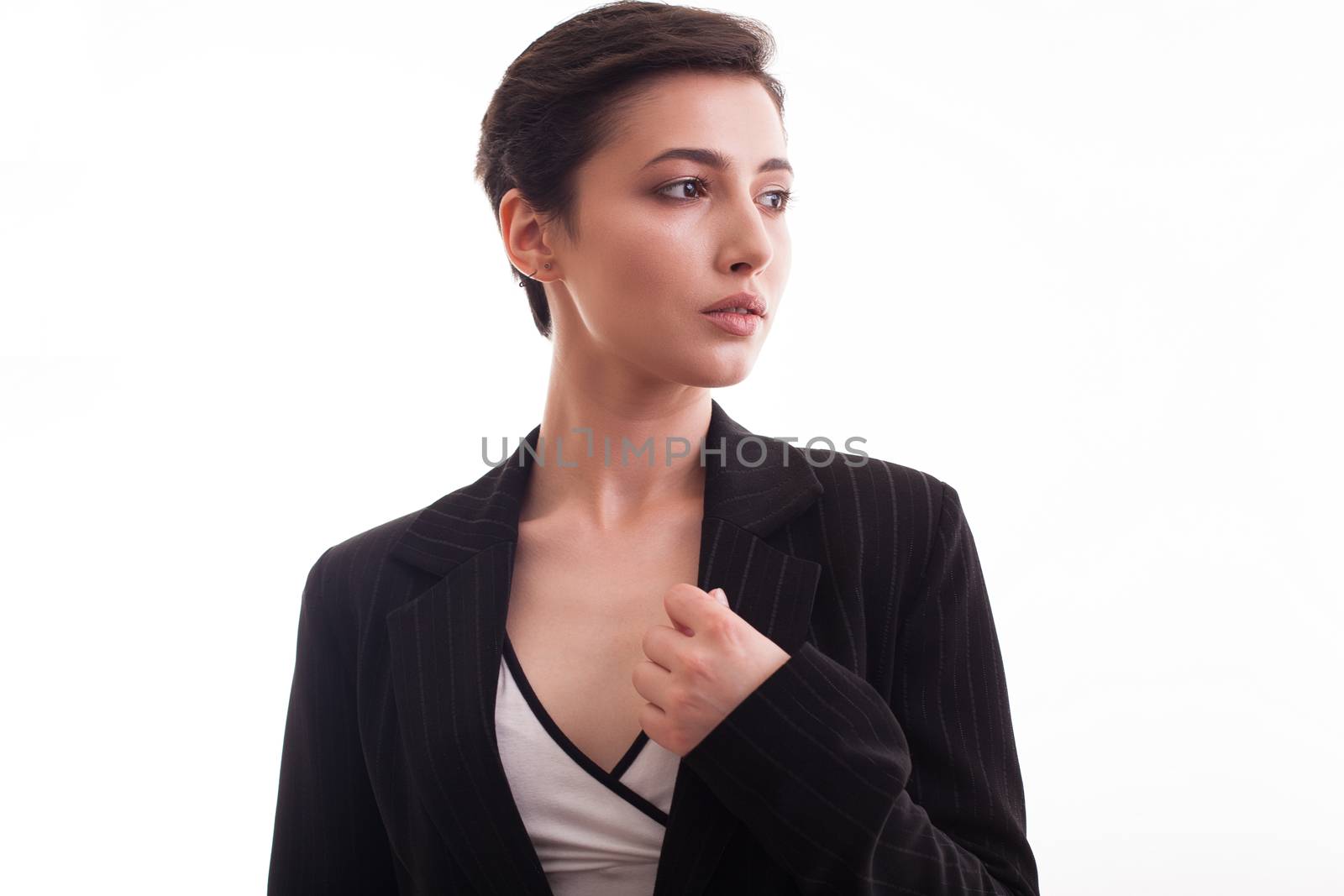 Beautiful young caucasian woman wearing a stylish black jacket over white background. Girl posing. Fashion studio.