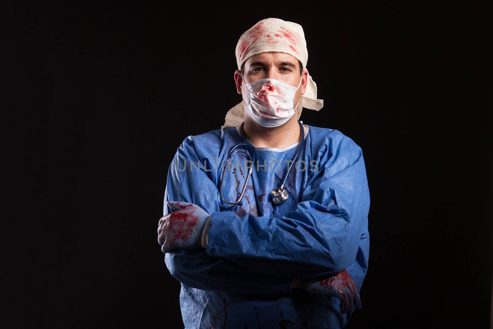 Man in doctor costume for halloween looking with a bizzare face at the camera. Weird male with medical costume.