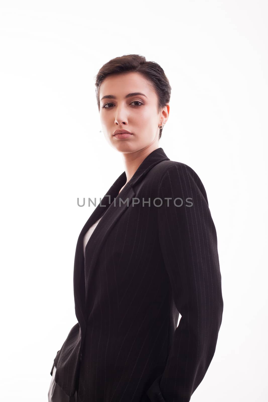 Charming young woman in studdio over white background wearing a black jacket. Casual clothes.