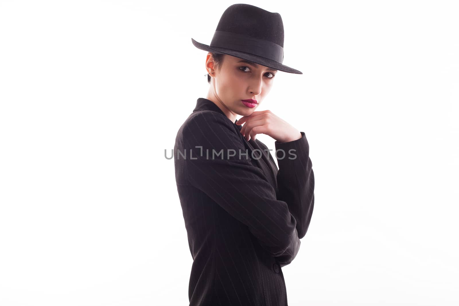 Beautiful lady wearing a stylish hat with a black jacket over white background in studio. Fashionable lady.