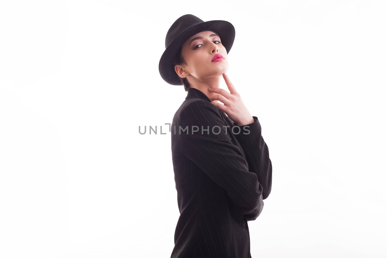 Beautiful lady wearing a stylish hat with a black jacket over white background in studio. Fashionable lady. Stylish clothing.