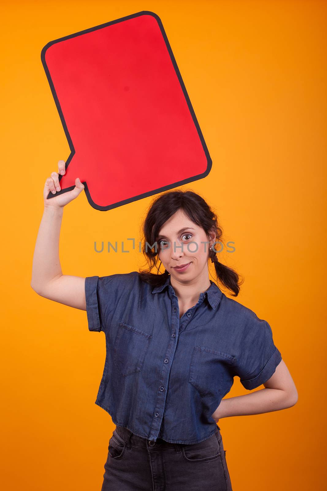 Young beautiful caucasian woman holding an empty tought bubble over her in studio over yellow background. Woman holding empty copy space. Beautiful young woman smiling with thought bubble.