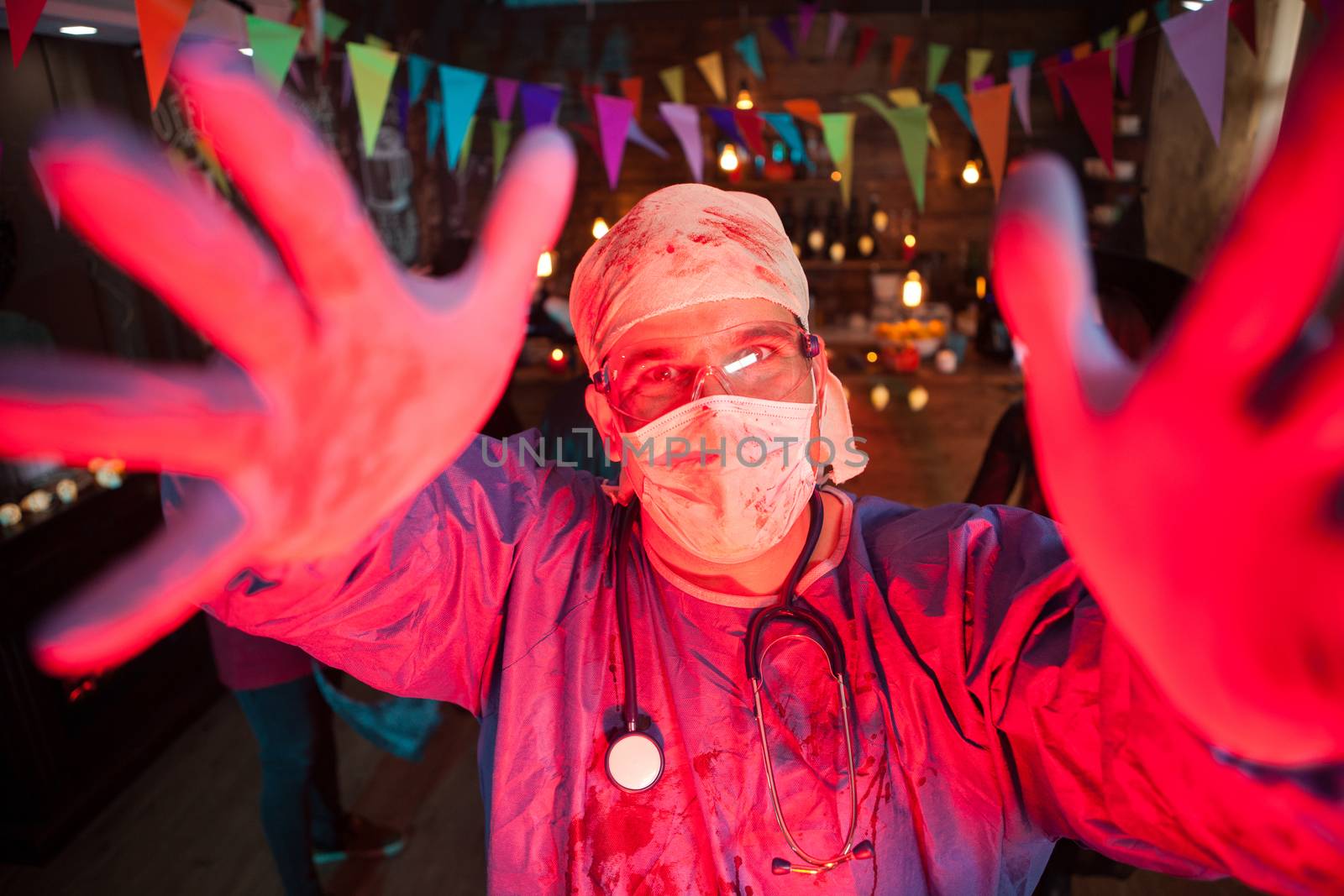 Man dressed up like a doctor having fun at a halloween party by DCStudio