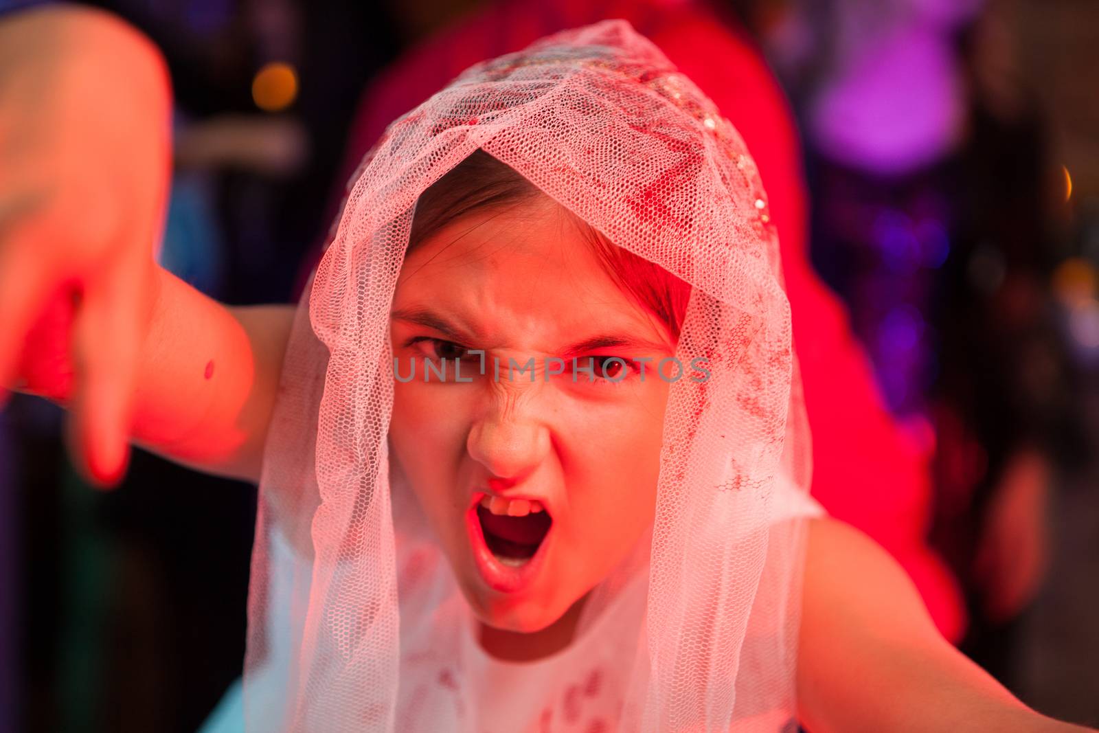 Close up portrait of screaming girl at a halloween party in weeding dress by DCStudio