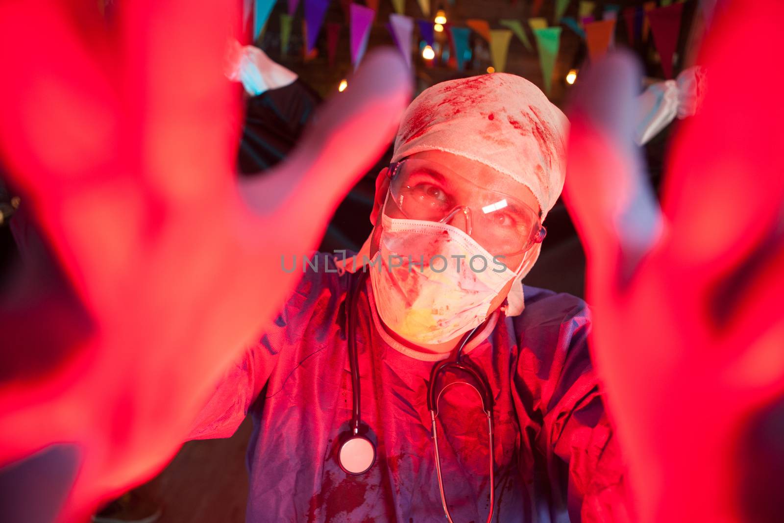 Handsome young doctor at a halloween party with a creepy express by DCStudio