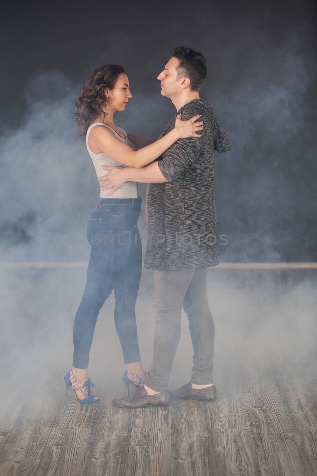 Male dancer looking at his dancing partner while dancing. Beautiful couple. Talented dancers.