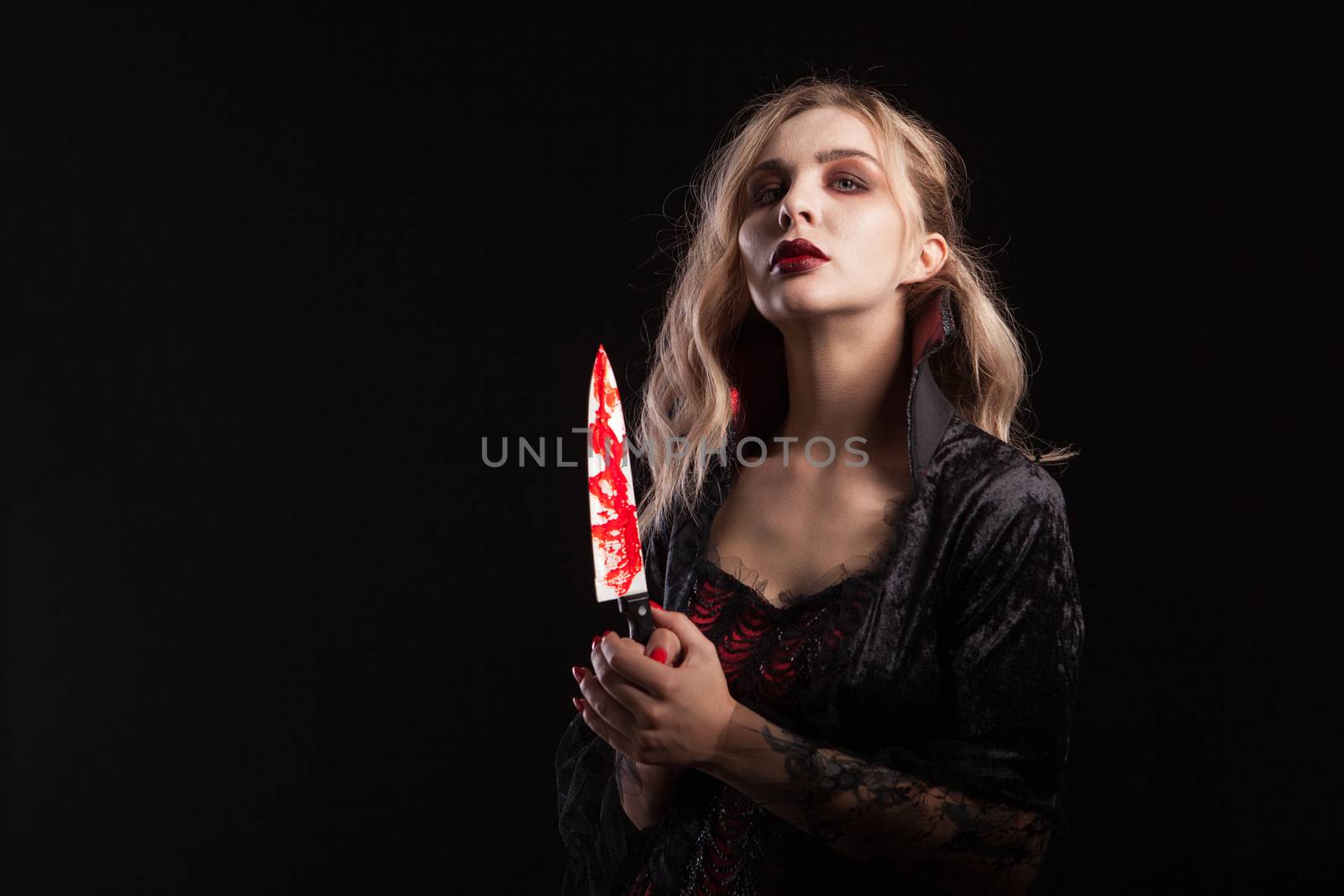 Portrait of sensual vampire woman dressed up for halloween carnival. Gorgeous vampire woman.